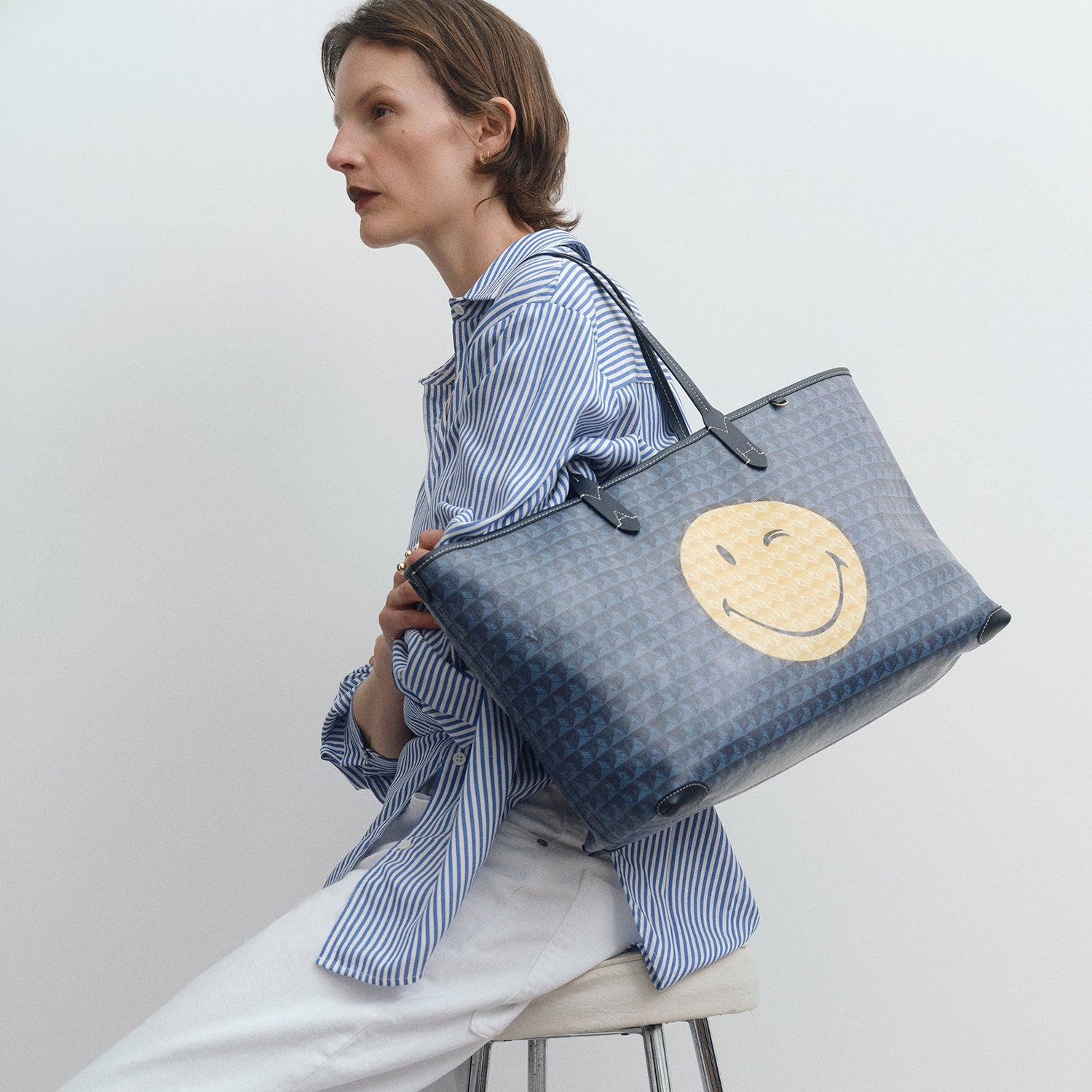 I am a Plastic Bag Wink Zipped Tote -

          
            Recycled Canvas in Marine -
          

          Anya Hindmarch UK
