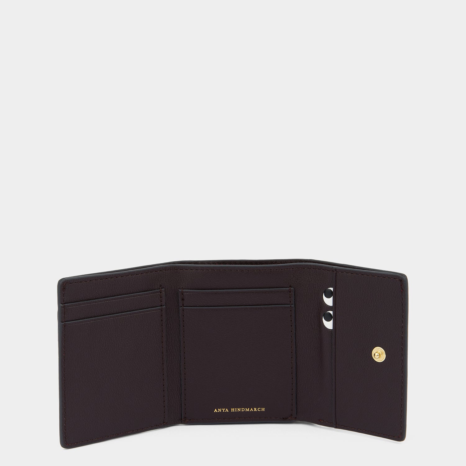 Peeping Eyes Mini Trifold Wallet -

          
            Capra Leather in Damson -
          

          Anya Hindmarch UK
