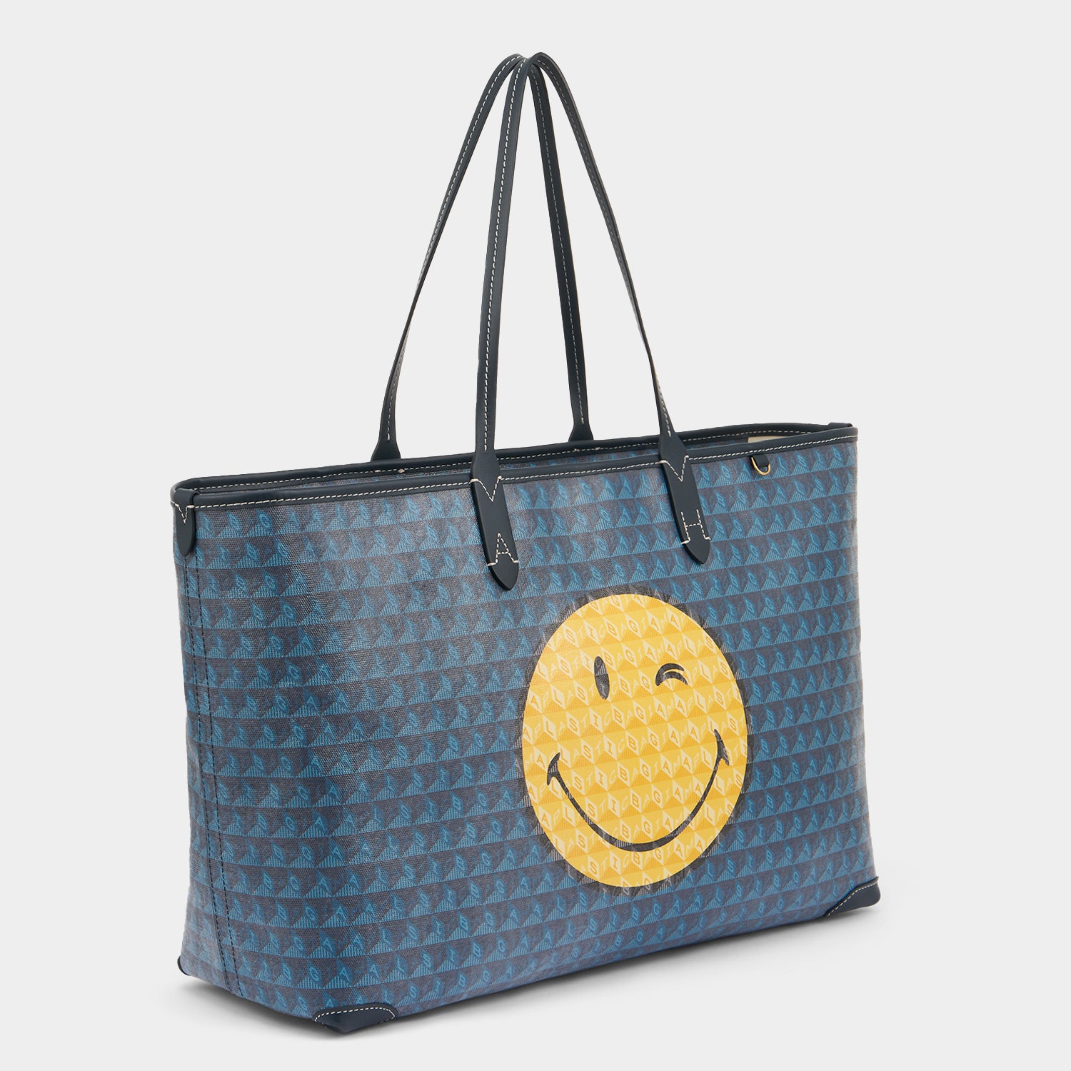 I am a Plastic Bag Wink Zipped Tote -

          
            Recycled Canvas in Marine -
          

          Anya Hindmarch UK
