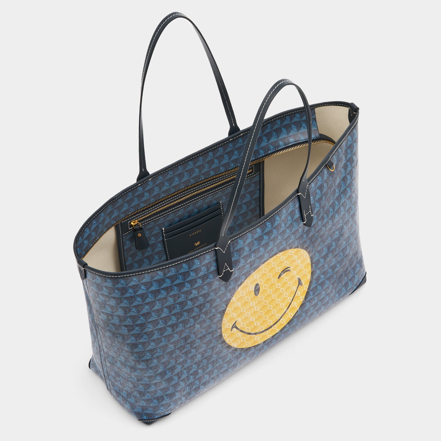 I am a Plastic Bag Wink Zipped Tote -

          
            Recycled Canvas in Marine -
          

          Anya Hindmarch UK
